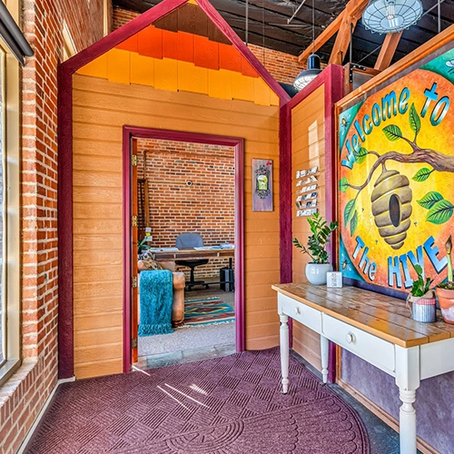 Bright, cheerful welcome area in the front entrance at the Hive Coworking Space in Downtown Cañon City, Colorado